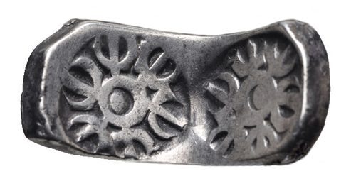 A punch-marked bent bar of the kind found in the Kabul hoard (not from the hoard).