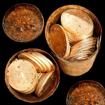 Small cans packed with gold coins, as recovered (photo Kagin's Inc.).