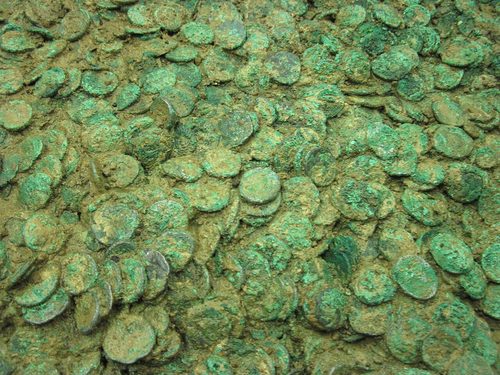 Corroded Coriosolite billon coins packed together in the block. Jersey Heritage.