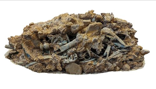A corroded mass of objects as lifted from the ground.
