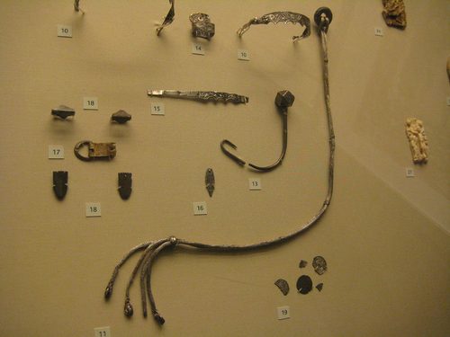 The silver scourge and smaller fittings from the hoard, in their display case. British Museum.