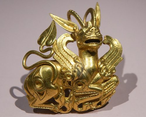 Gold plaque of a horned lion-griffin, once inlaid.
