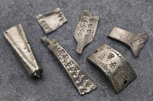 Cut pieces of stamped silver from the hoard. Photo: NTNU University Museum.