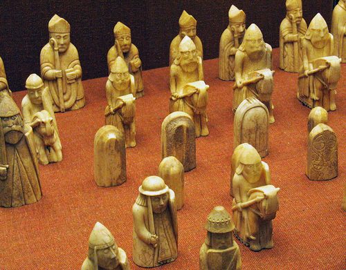 Lewis chessmen arranged on a board at the British Museum.