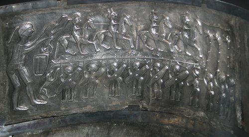 Inner plate with a procession of warriors and carnyx players.