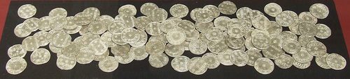 Silver pennies from the hoard laid out for display.