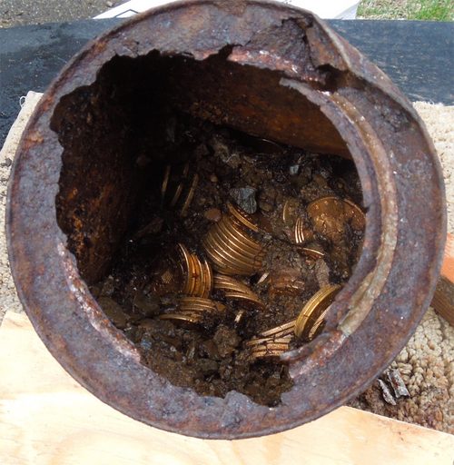 One of the rusted cans with gold coins still inside (photo Kagin's Inc.).