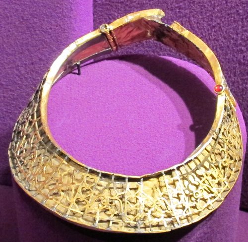 A gold collar set with stones.